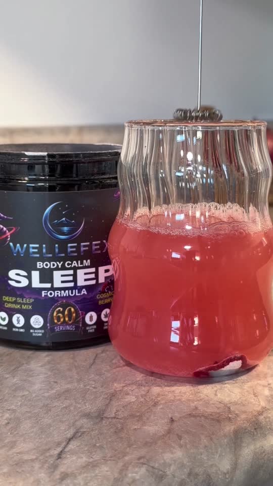 A glass of mixed Cosmic Berry drink beside the tub